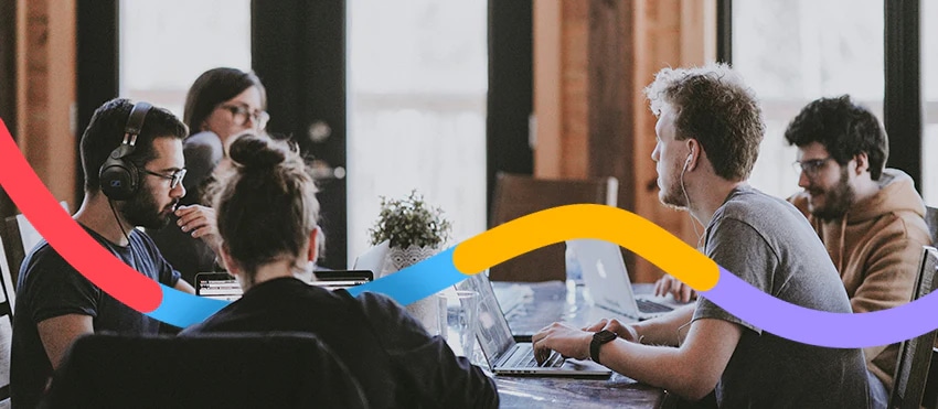 Group of young professionals in a collaborative meeting with colorful overlay lines.